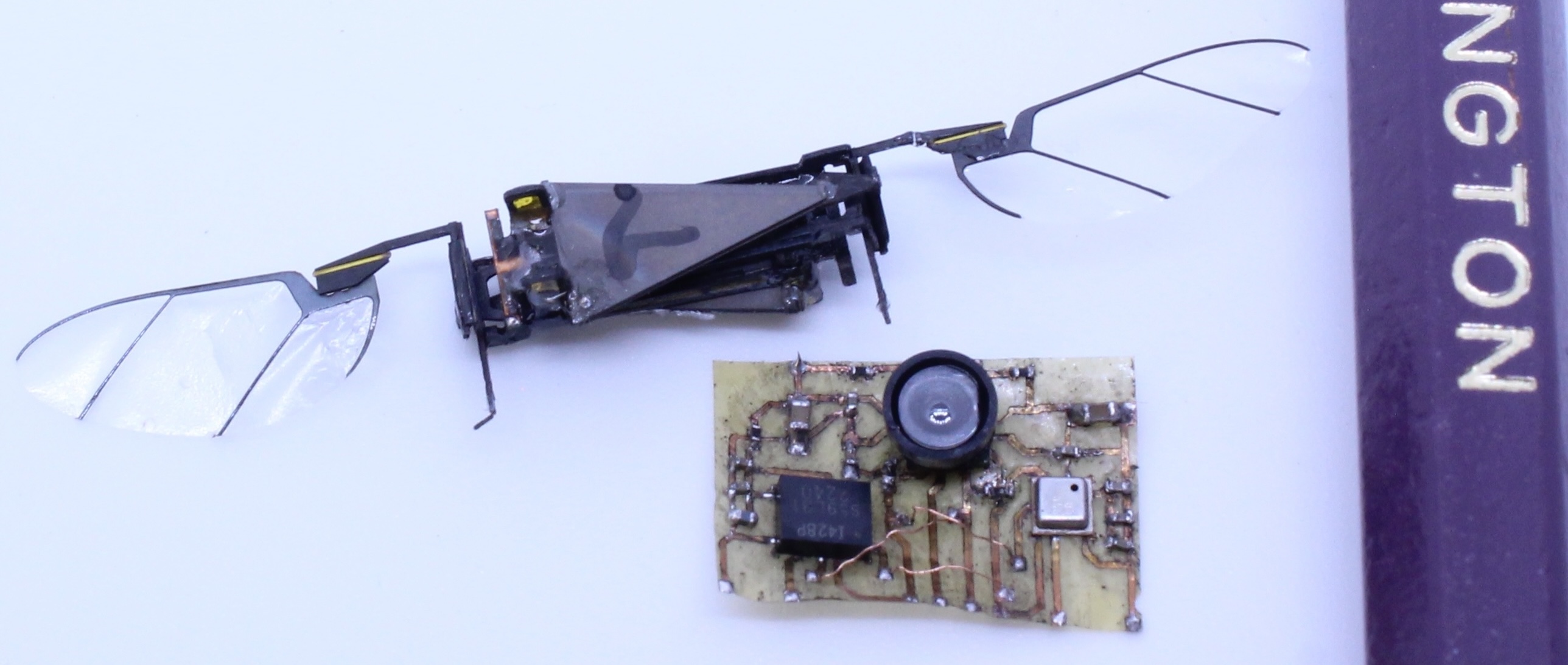 The TinySense next to the RoboFly and a pencil